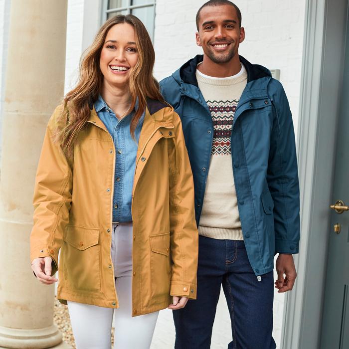 Smiling models in colourful smart raincoats